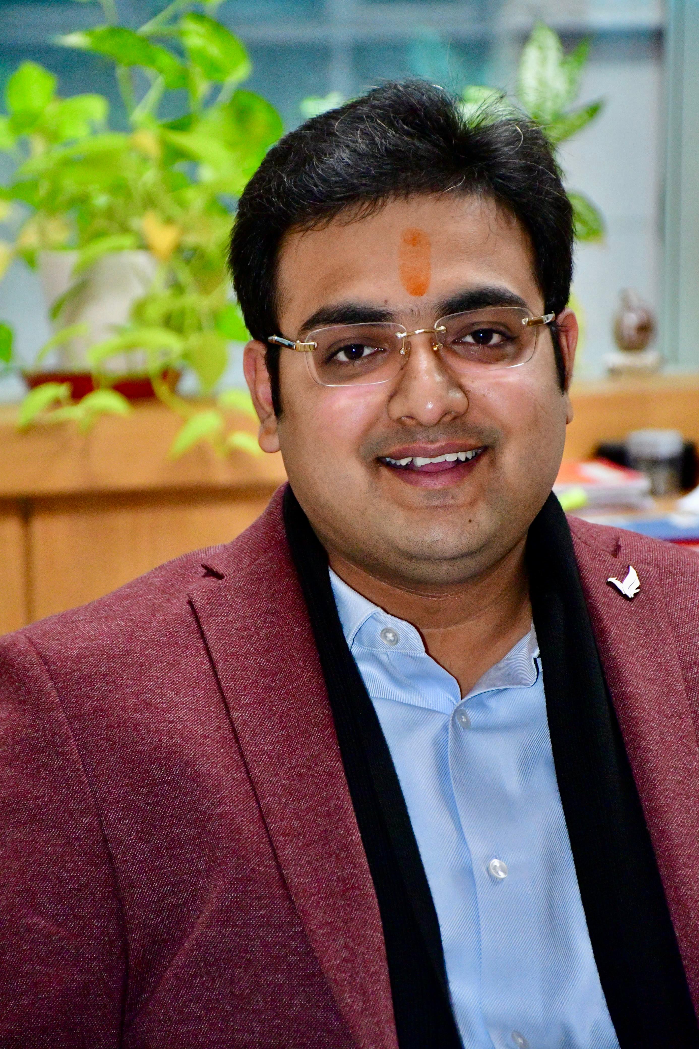 Headshot in maroon blazer